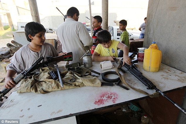 Rebels-in-waiting: The children as young as SEVEN being trained to fight on the front lines against Gaddafi